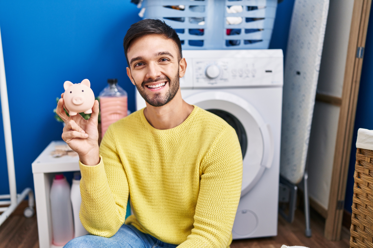 Guy With Piggy Bank In Laundry Room 1200X800